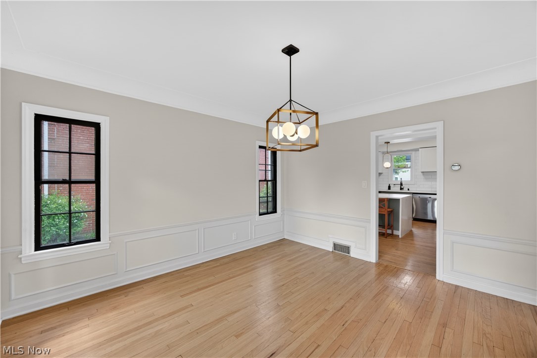 2561 Charney Road Cleveland, OH 44118 - Photo 10 of 47 The Dining Room with refinished hardwood floor, cove ceiling and elegant wainscot