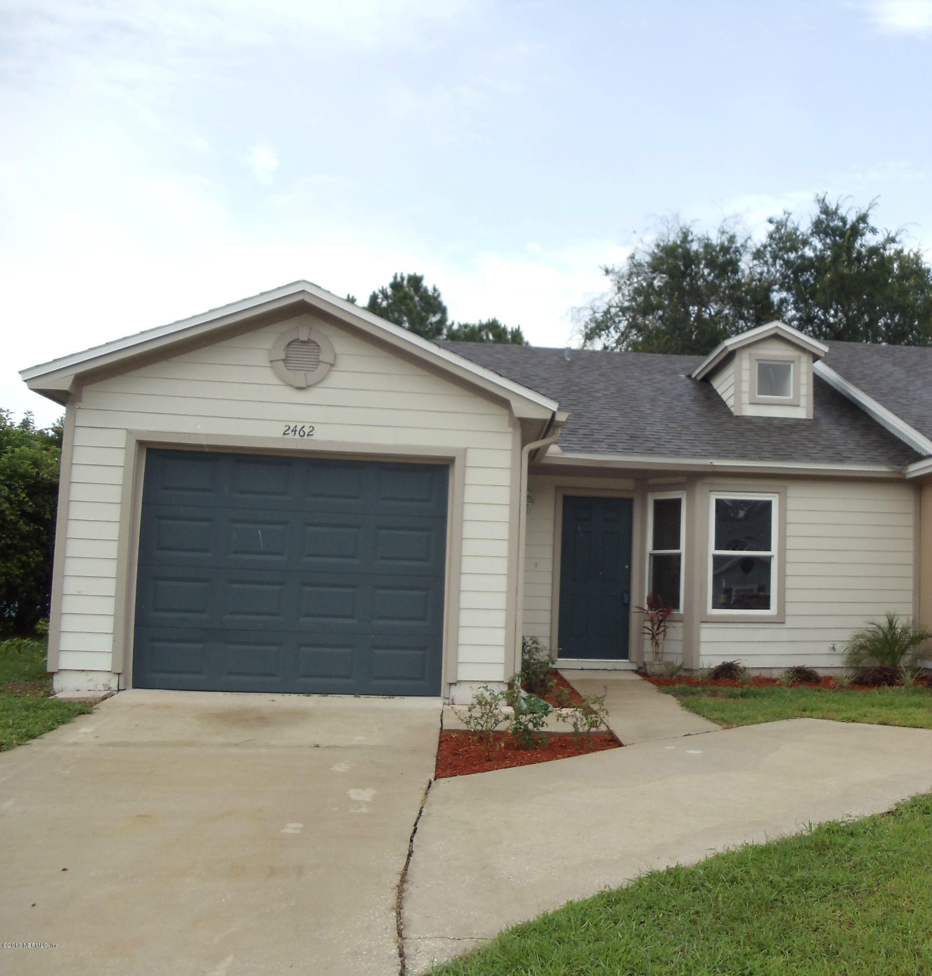 2462 Wattle Tree Road East Jacksonville, FL 32246 - Photo 1 of 35 a front view of a house with yard garage and garage