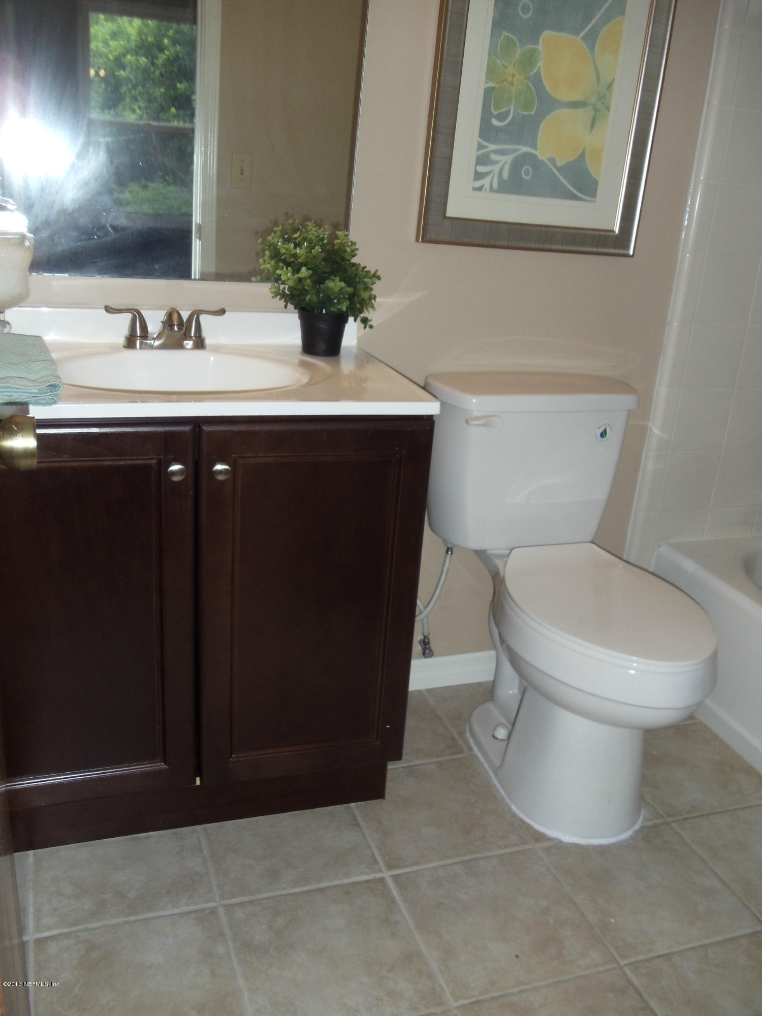 2462 Wattle Tree Road East Jacksonville, FL 32246 - Photo 11 of 35 a bathroom with a toilet sink and mirror