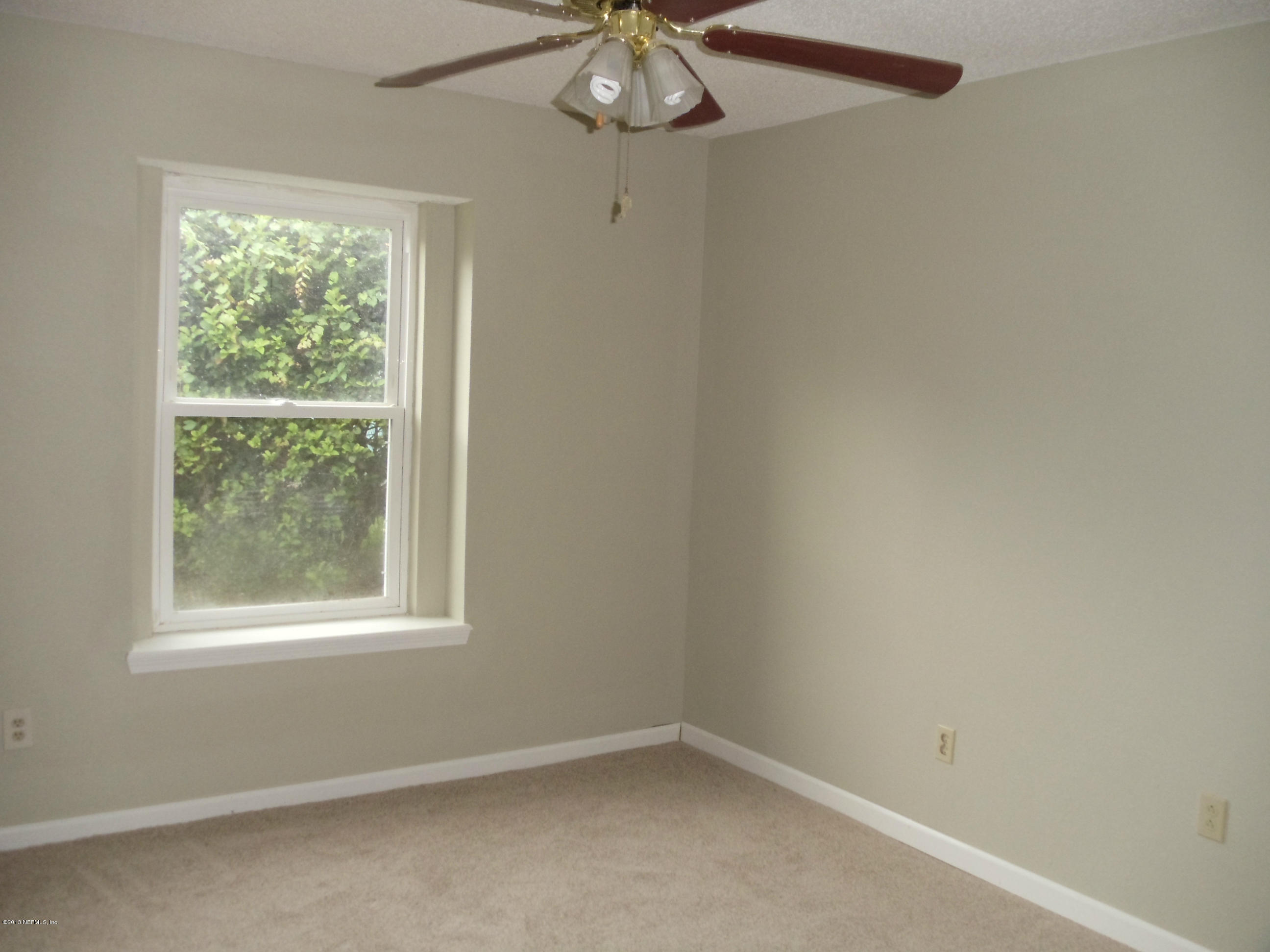 2462 Wattle Tree Road East Jacksonville, FL 32246 - Photo 14 of 35 an empty room with a window