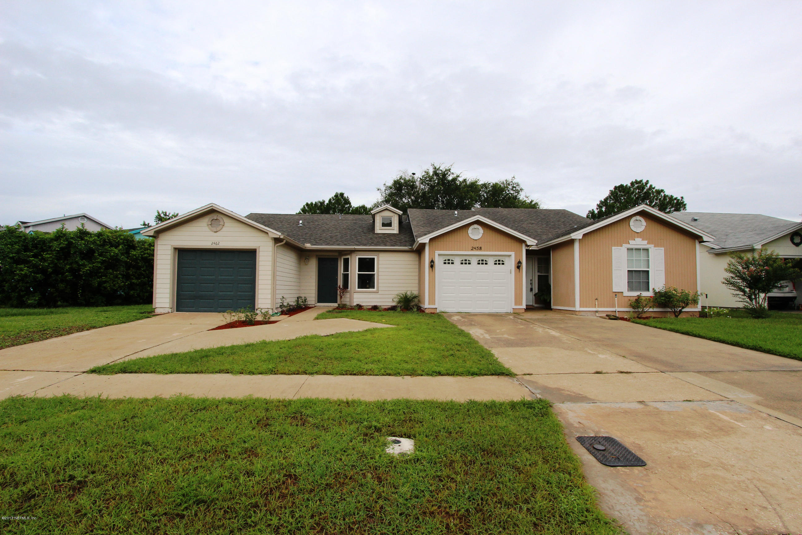 2462 Wattle Tree Road East Jacksonville, FL 32246 - Photo 17 of 35 a front view of a house with a yard and garage