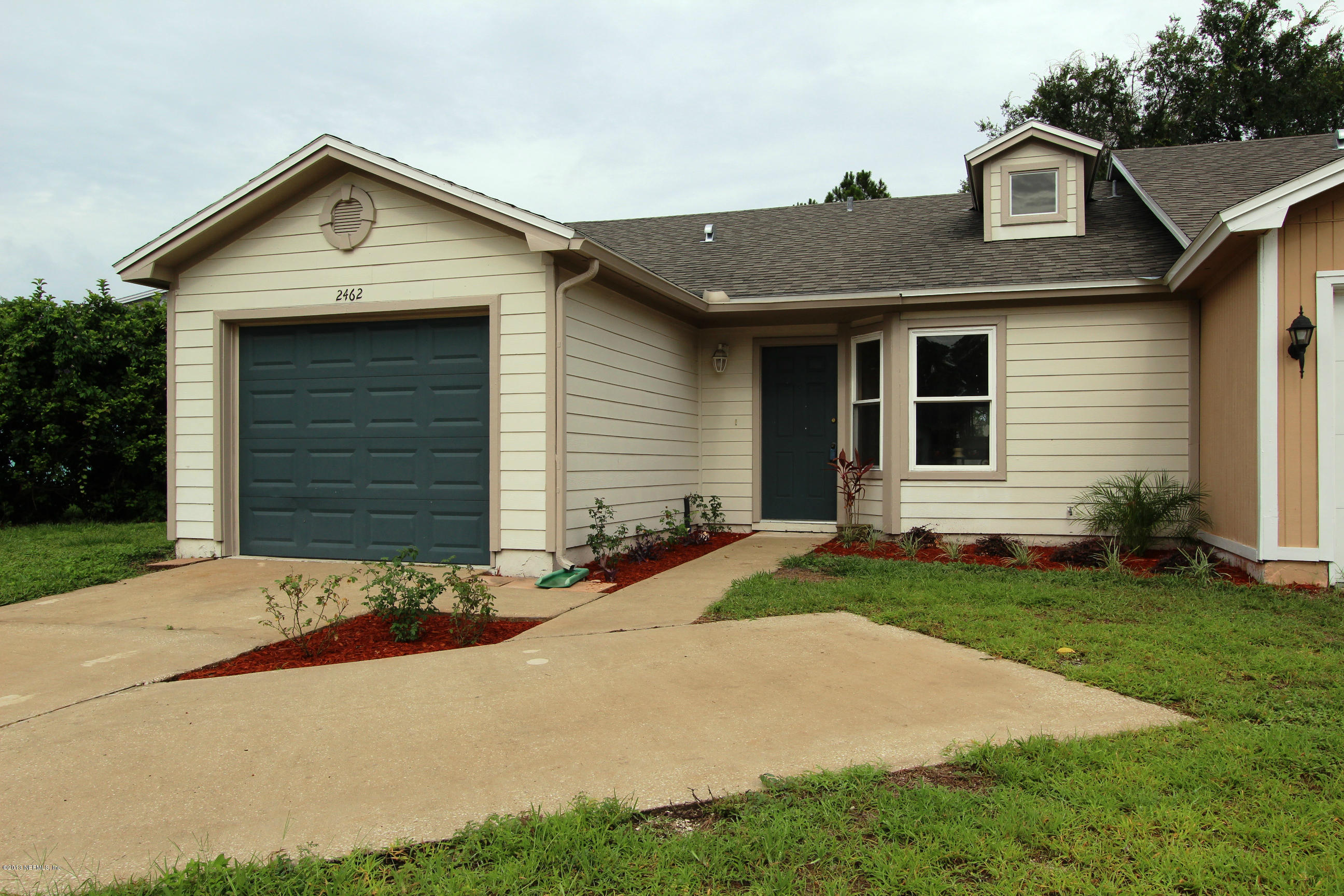 2462 Wattle Tree Road East Jacksonville, FL 32246 - Photo 18 of 35 a front view of a house with a yard and garage