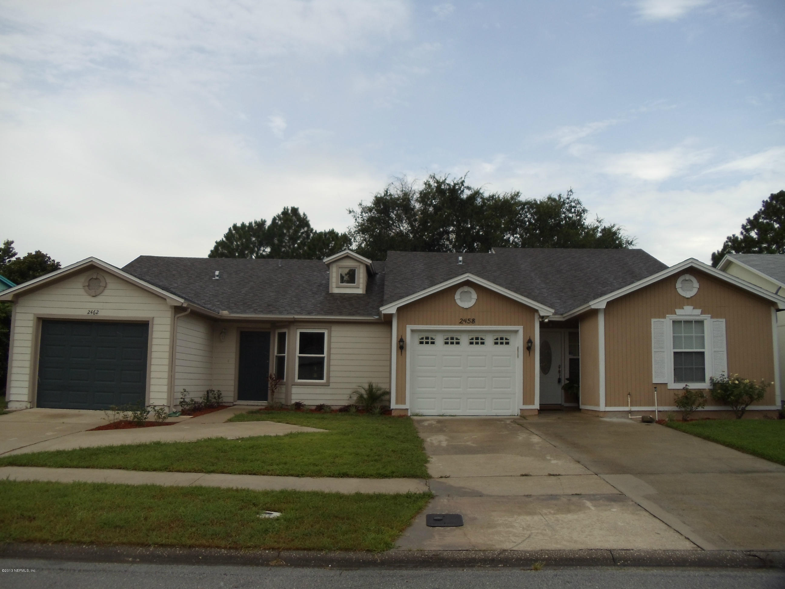 2462 Wattle Tree Road East Jacksonville, FL 32246 - Photo 2 of 35 a front view of a house with a garden