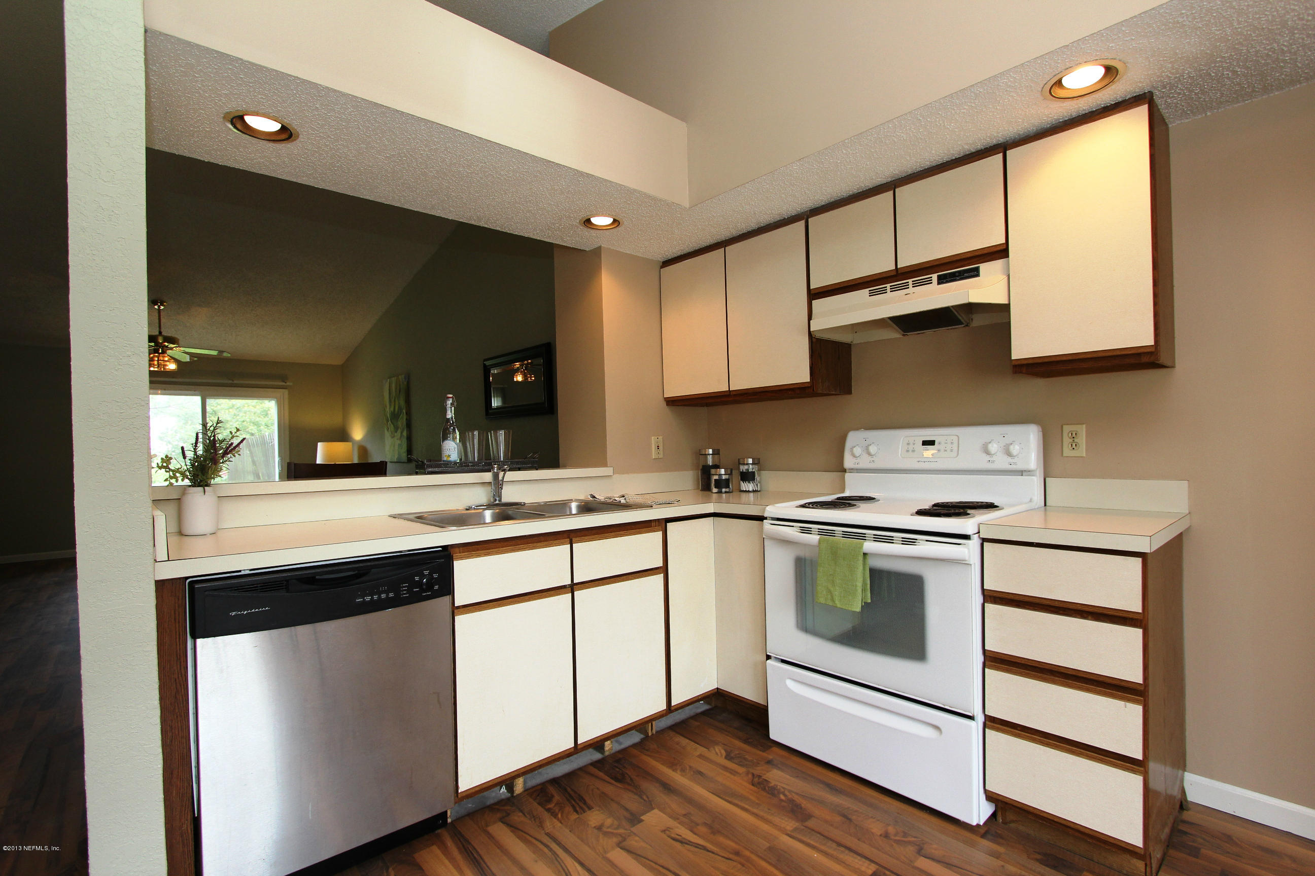 2462 Wattle Tree Road East Jacksonville, FL 32246 - Photo 25 of 35 a kitchen with a sink stove and cabinets