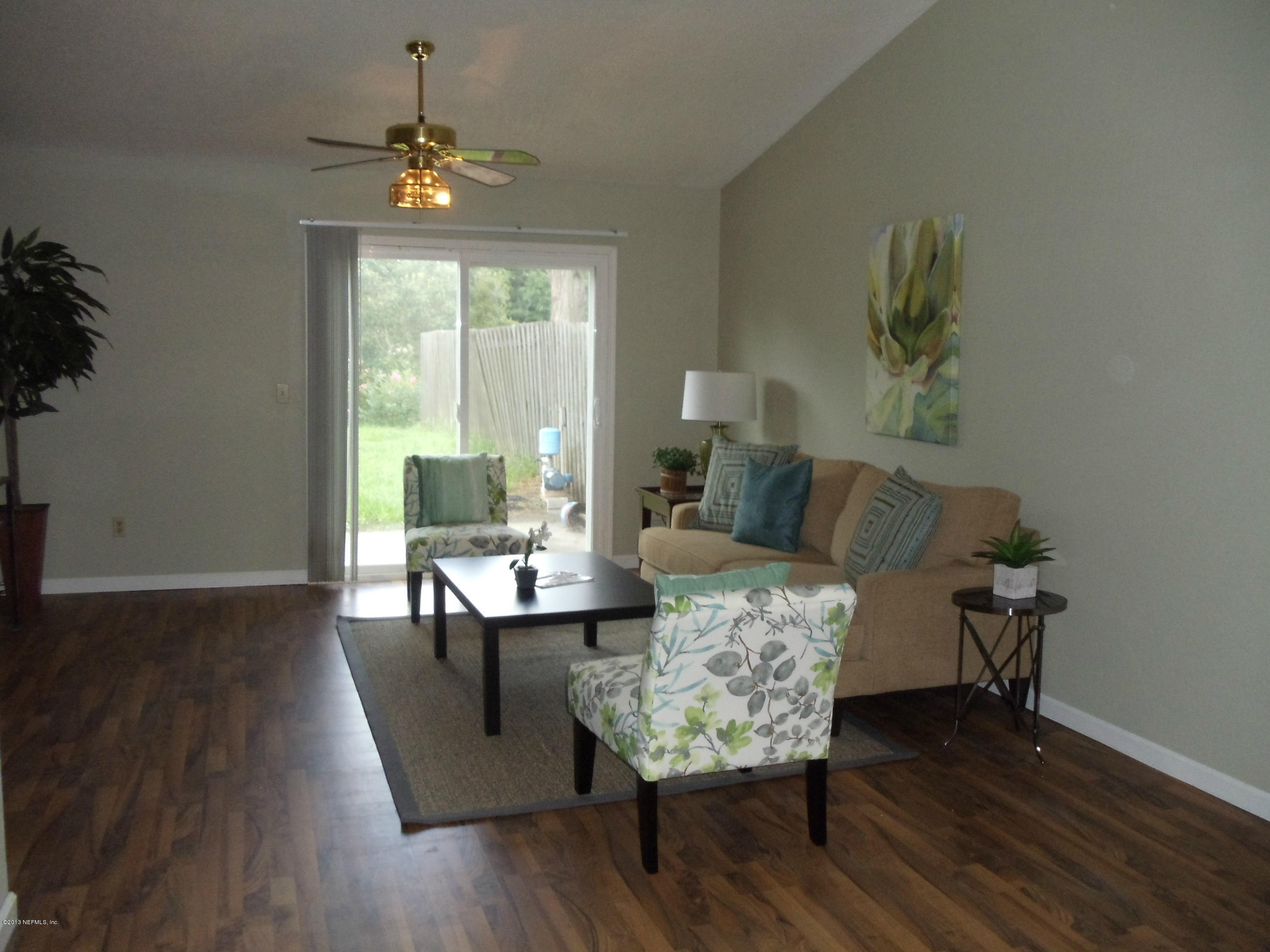 2462 Wattle Tree Road East Jacksonville, FL 32246 - Photo 3 of 35 a living room with furniture and a wooden floor