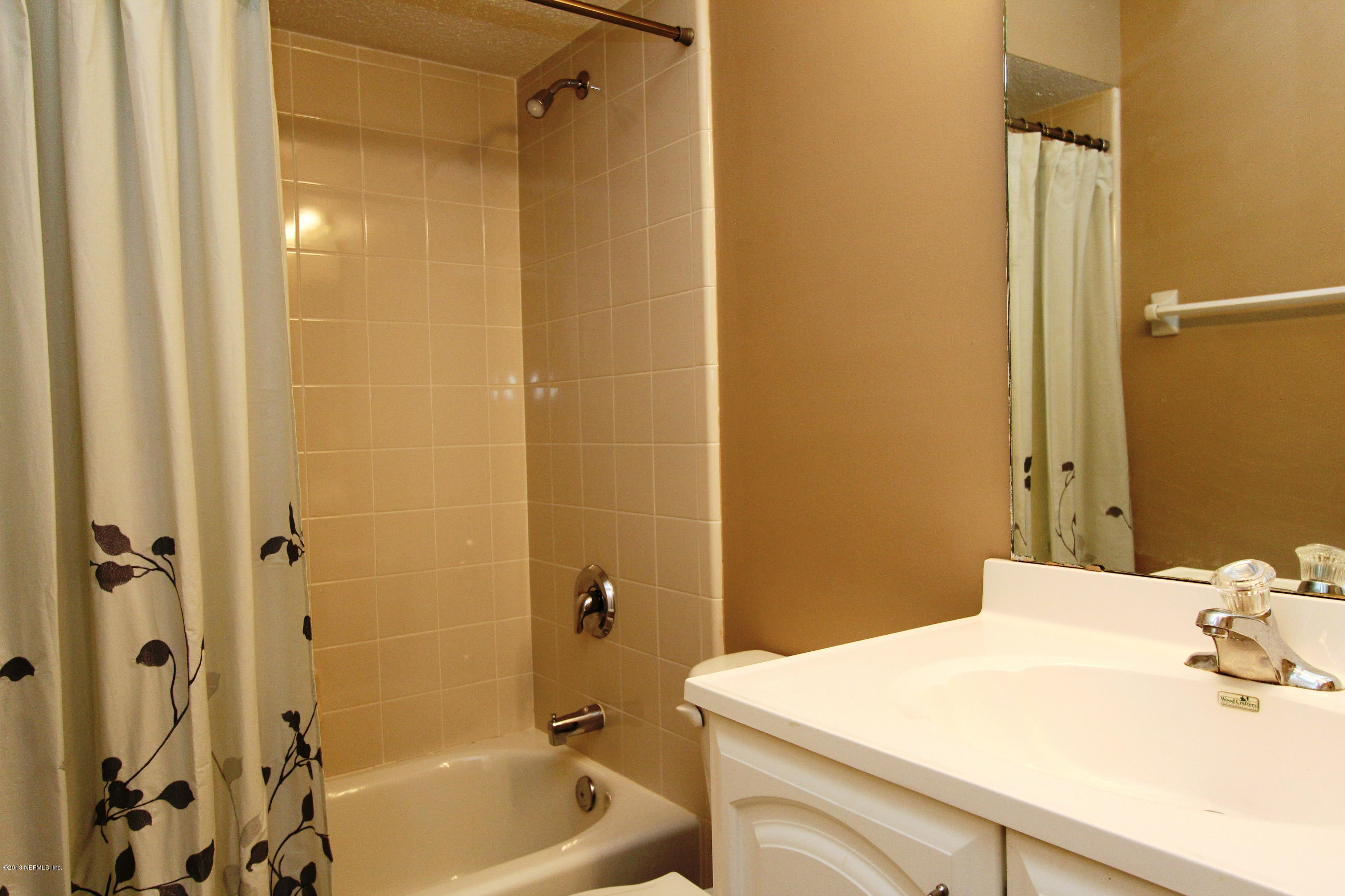 2462 Wattle Tree Road East Jacksonville, FL 32246 - Photo 32 of 35 a bathroom with a sink a toilet and shower