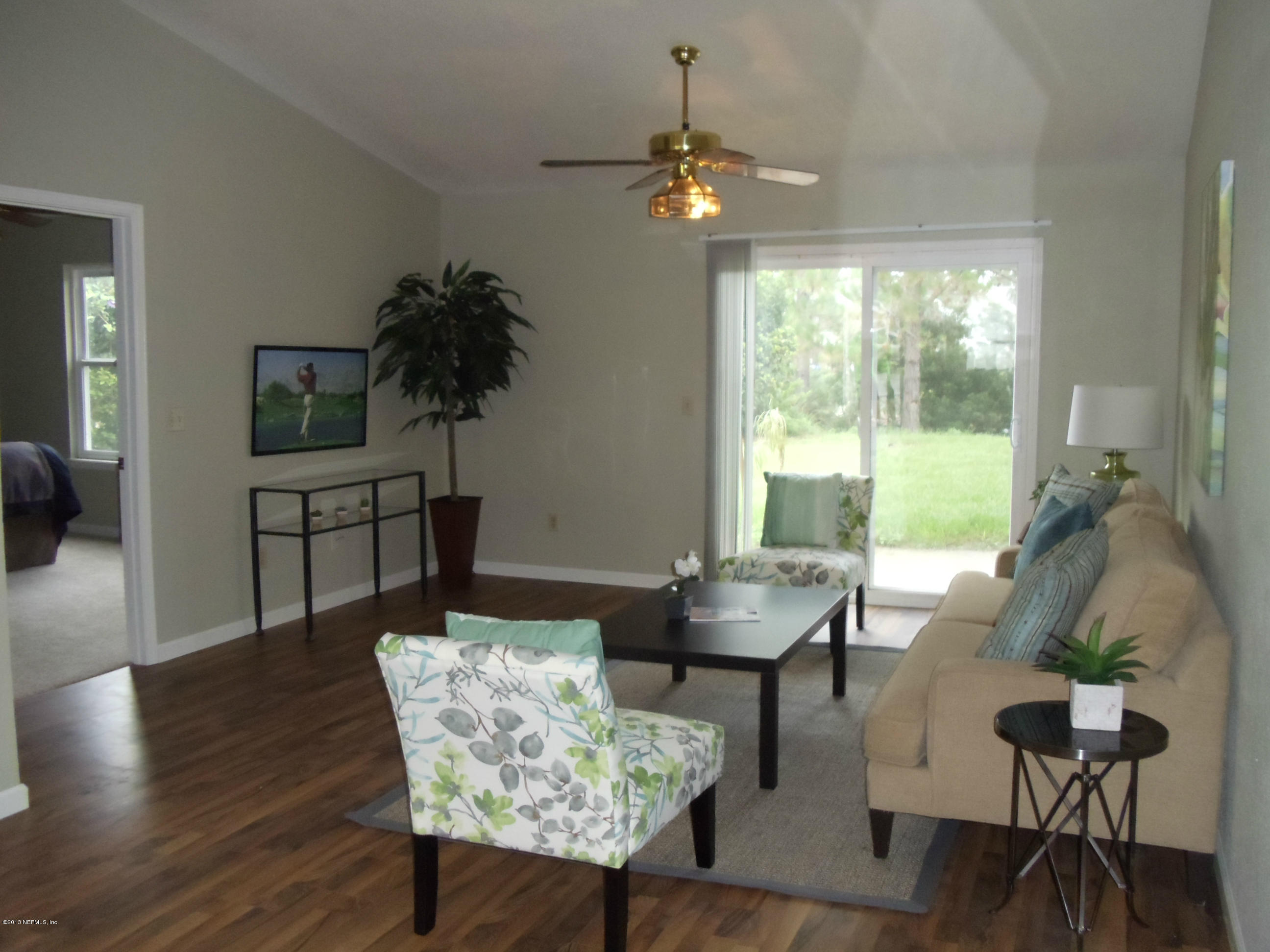 2462 Wattle Tree Road East Jacksonville, FL 32246 - Photo 4 of 35 a living room with furniture and a large window