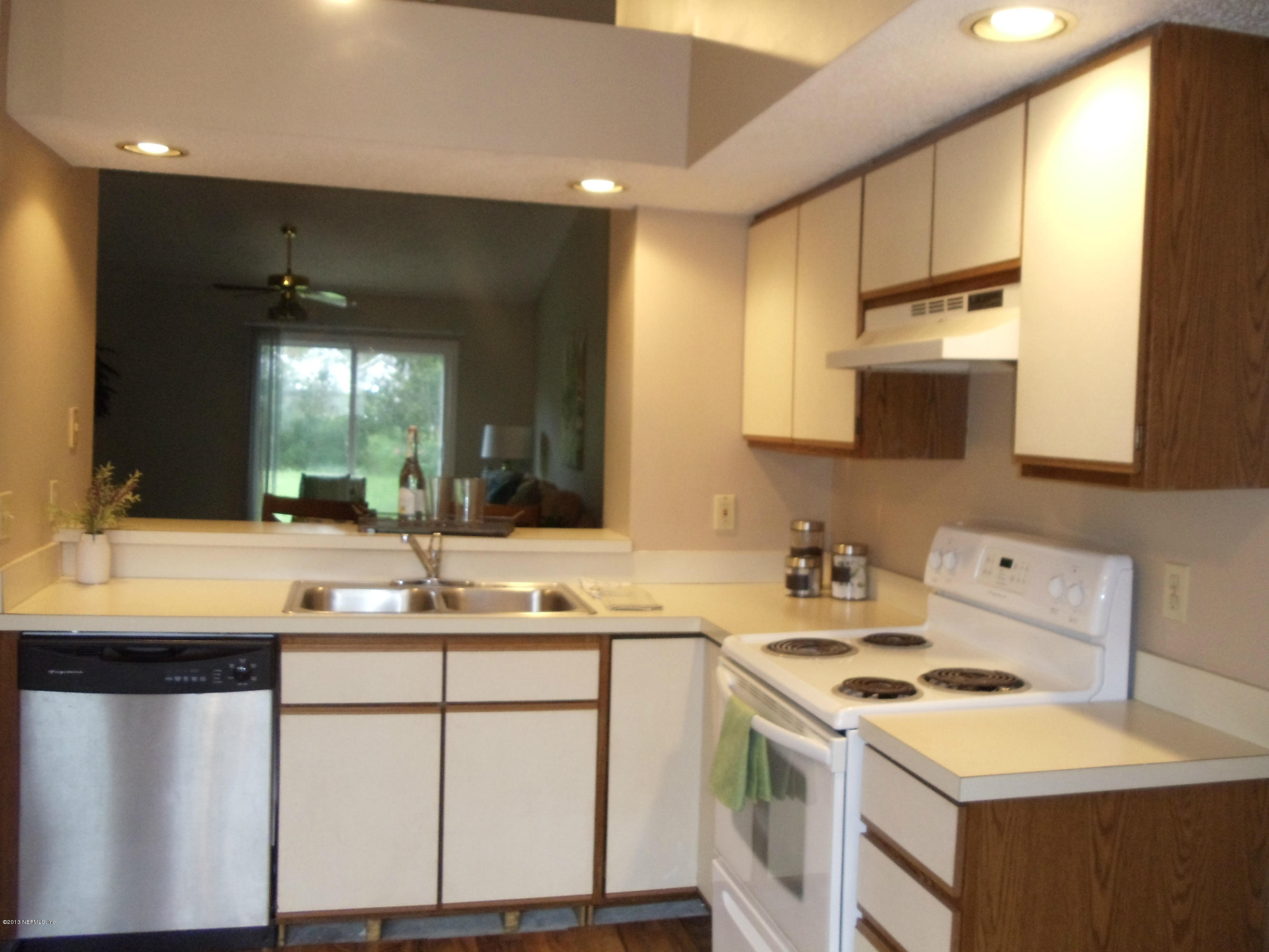 2462 Wattle Tree Road East Jacksonville, FL 32246 - Photo 8 of 35 a kitchen with a sink a stove and cabinets