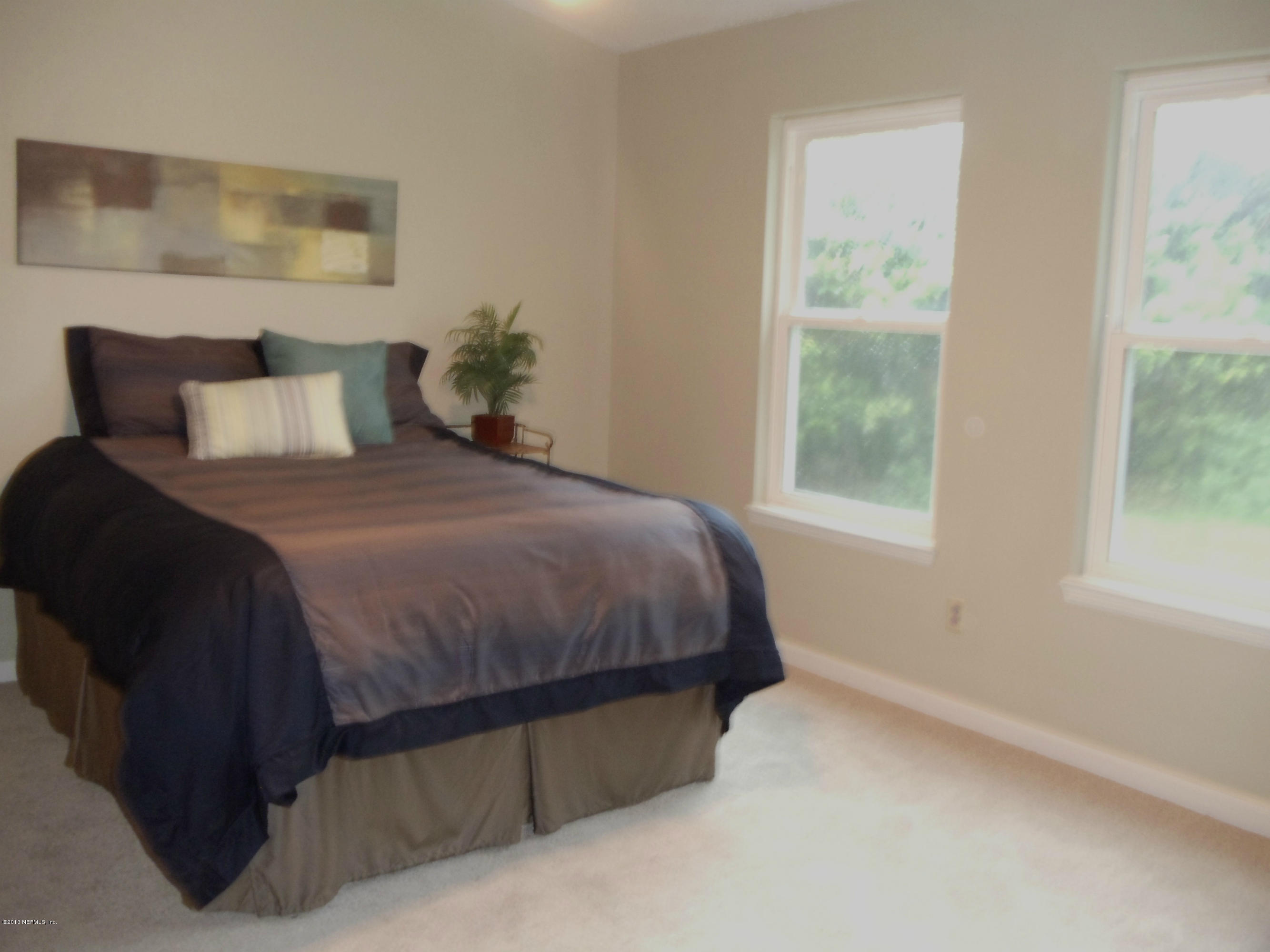 2462 Wattle Tree Road East Jacksonville, FL 32246 - Photo 10 of 35 a bedroom with a bed and window