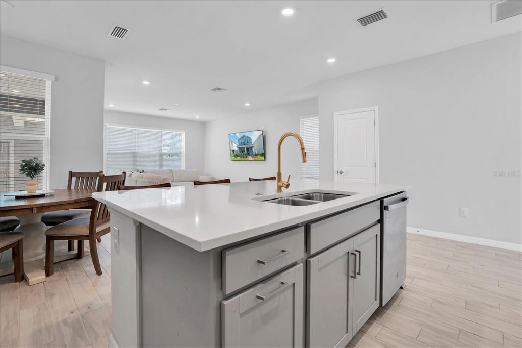 13639 Rangeland Boulevard Odessa, FL 33556 - Photo 12 of 63 a kitchen with a sink window and chairs