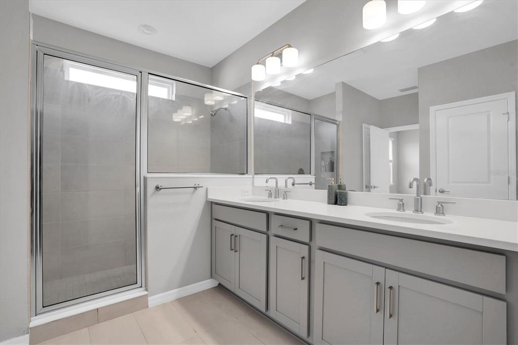 13639 Rangeland Boulevard Odessa, FL 33556 - Photo 20 of 63 a bathroom with a double vanity sink and a mirror