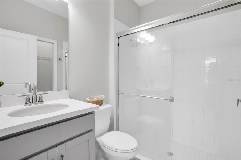 13639 Rangeland Boulevard Odessa, FL 33556 - Photo 29 of 63 a bathroom with a sink toilet and shower