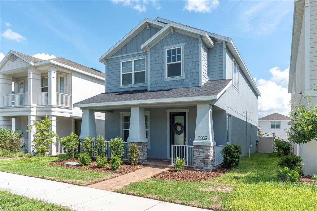 13639 Rangeland Boulevard Odessa, FL 33556 - Photo 38 of 63 a front view of a house with garden