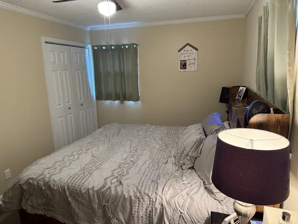a bedroom with a bed and a chandelier