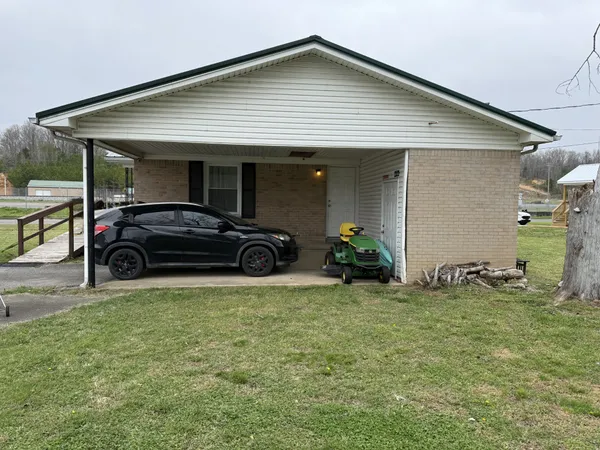 a view of a house with backyard and porch