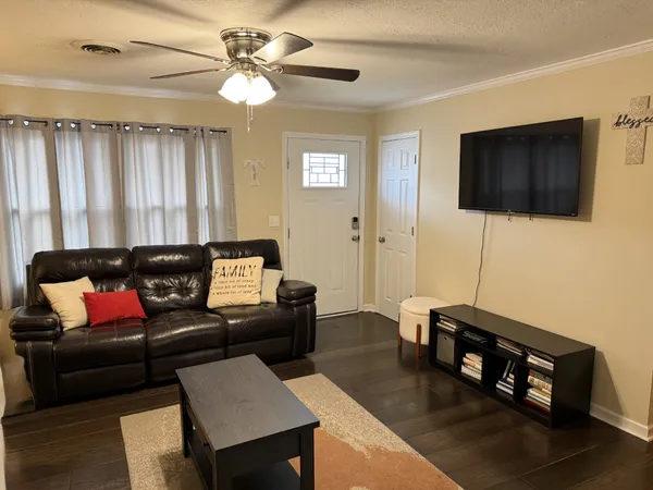 a living room with furniture and a flat screen tv