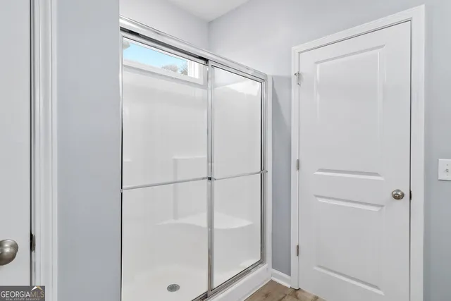 a bathroom with a glass shower door