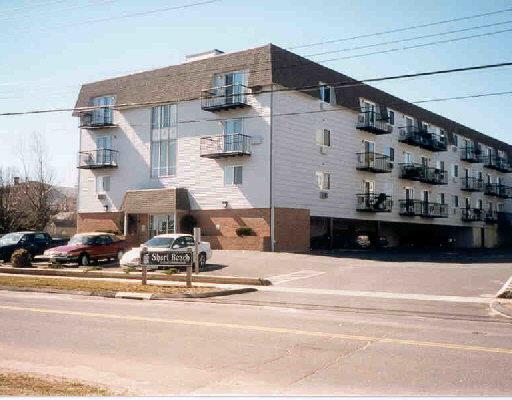 a view of a building with cars parked