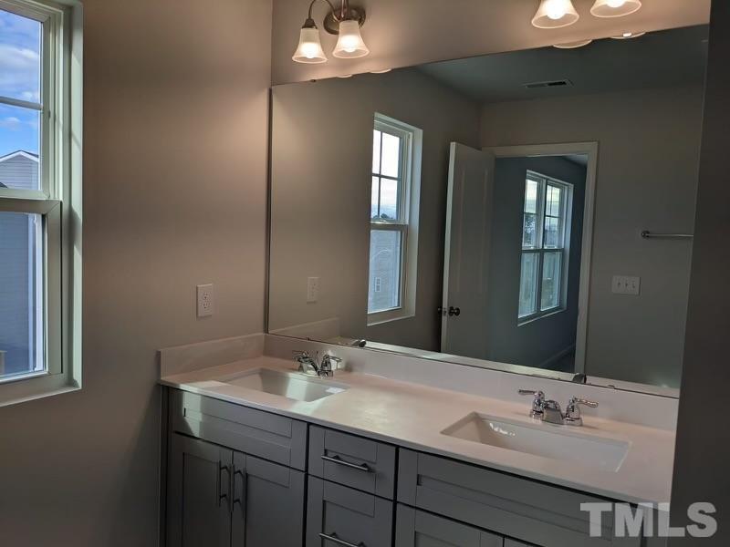 205 Nahunta Drive Apex, NC 27539 - Photo 12 of 24 a bathroom with double vanity sinks and a mirror