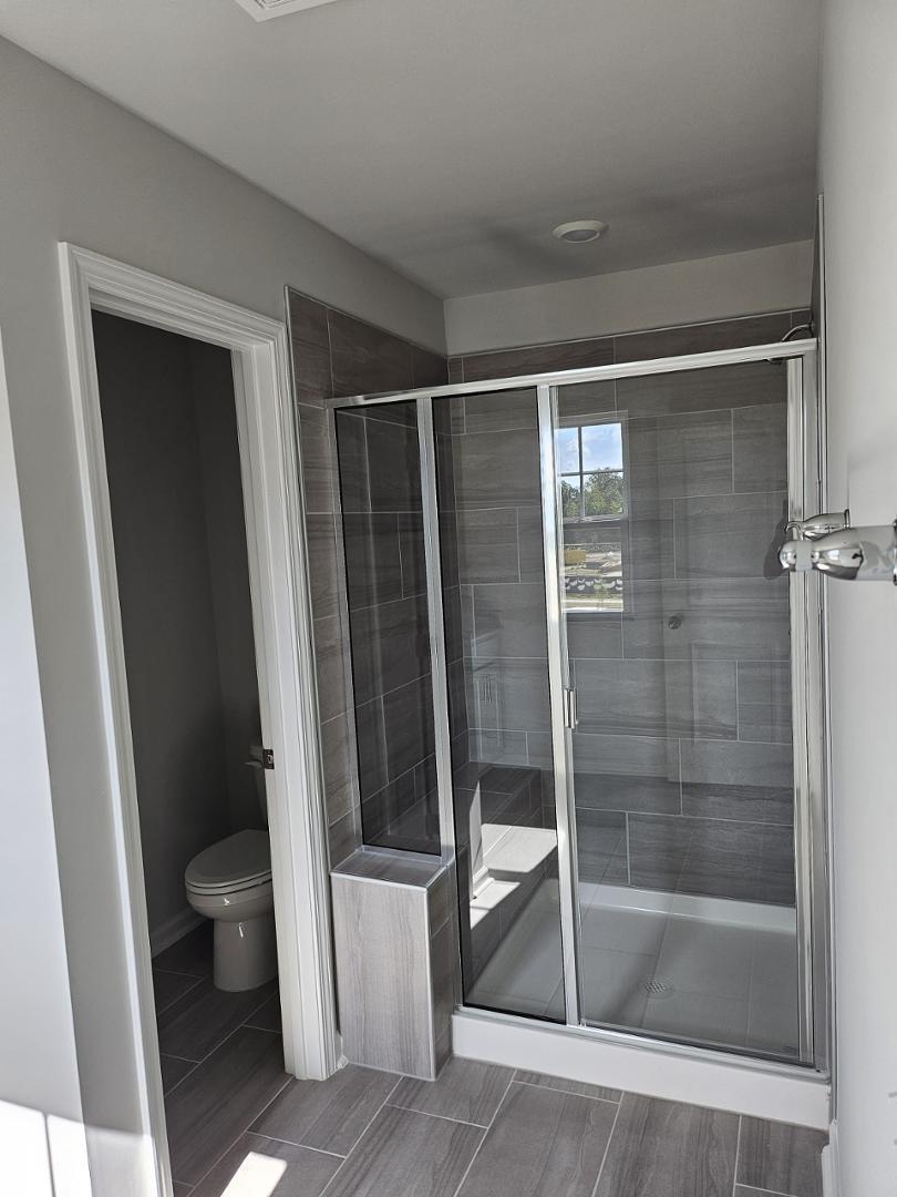 205 Nahunta Drive Apex, NC 27539 - Photo 19 of 24 a bathroom with a shower and toilet