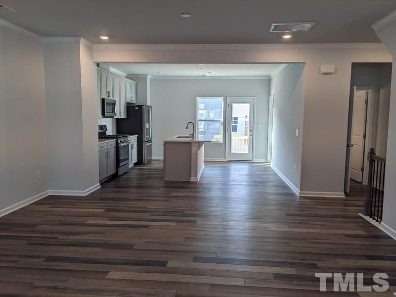 205 Nahunta Drive Apex, NC 27539 - Photo 7 of 24 a view of a dining room with furniture and wooden floor