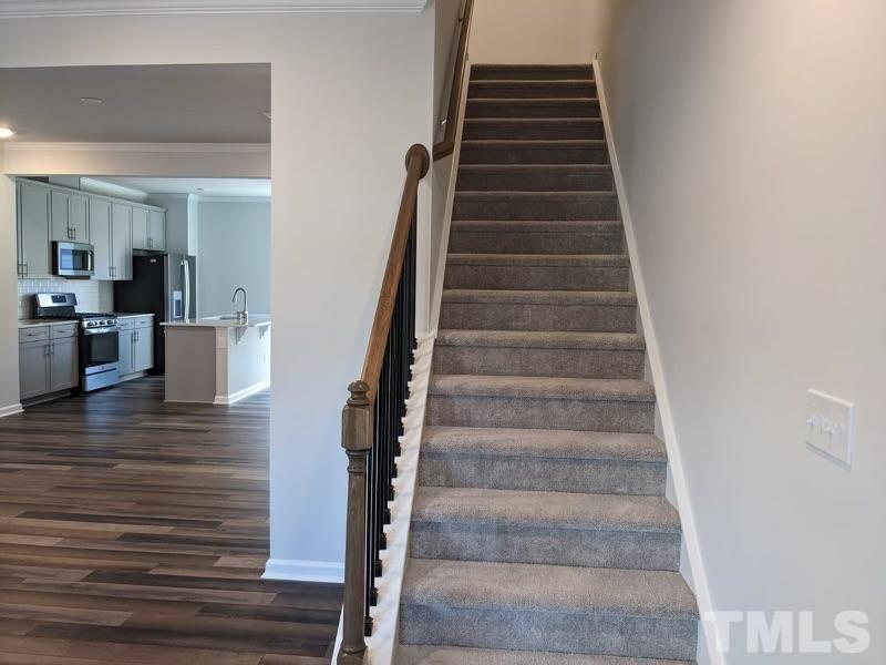 205 Nahunta Drive Apex, NC 27539 - Photo 8 of 24 a view of entryway and hall with wooden floor