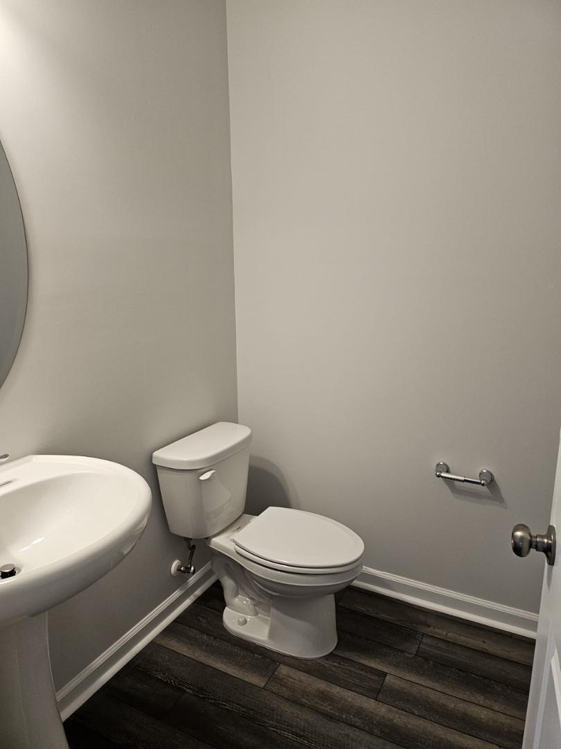 205 Nahunta Drive Apex, NC 27539 - Photo 10 of 24 a white toilet sitting next to a white wall