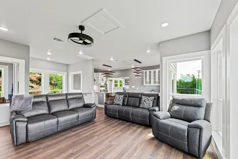 a view of a living room a wooden floor and a large window