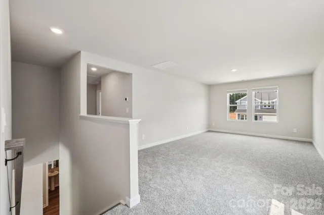 an empty room with windows and cabinet