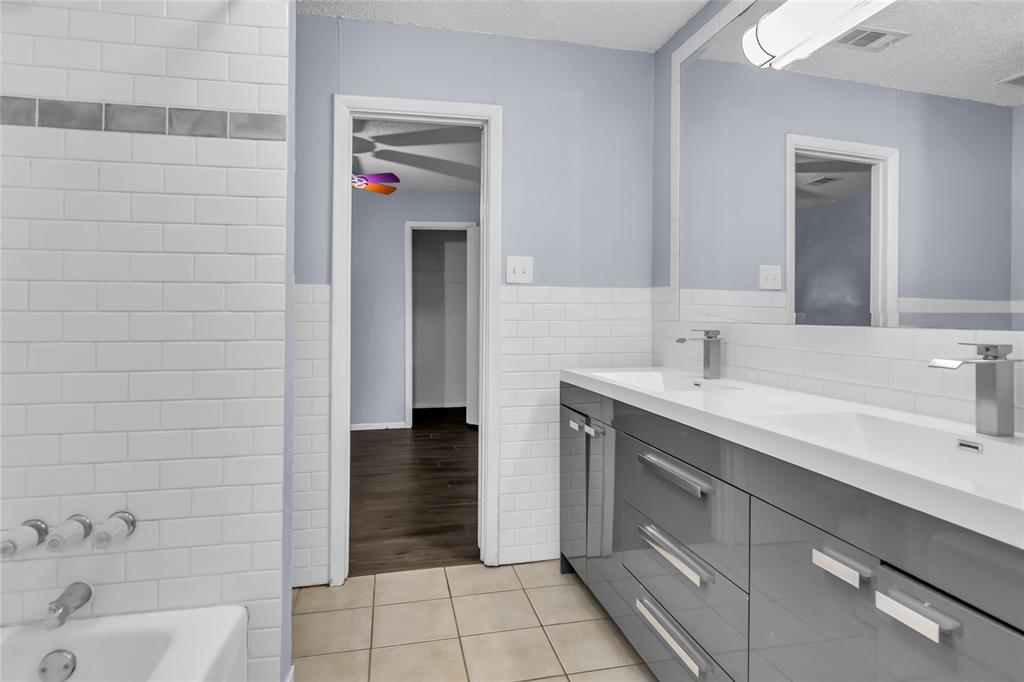 805 Irwin Drive, Unit B Hurst, TX 76053 - Photo 17 of 26 a bathroom with a sink and a shower