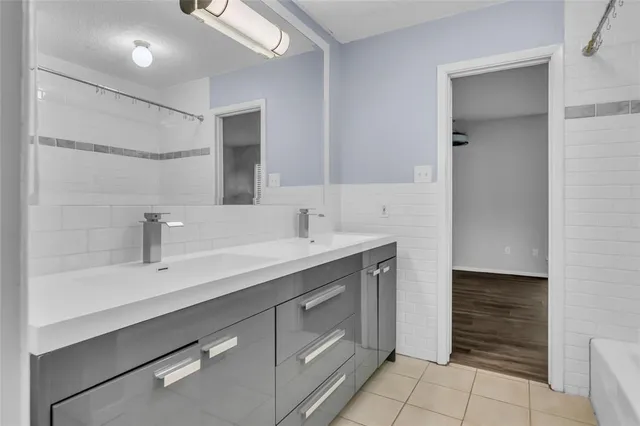 a spacious bathroom with a sink and a mirror