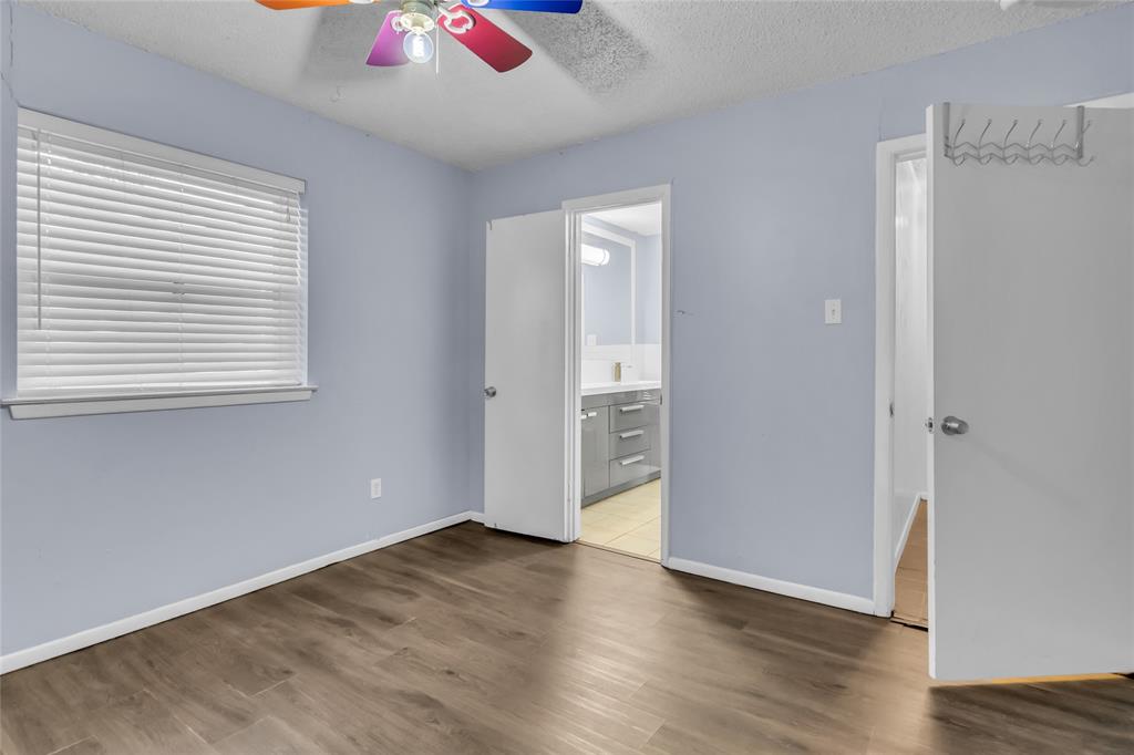 805 Irwin Drive, Unit B Hurst, TX 76053 - Photo 20 of 26 an empty room with wooden floor and windows