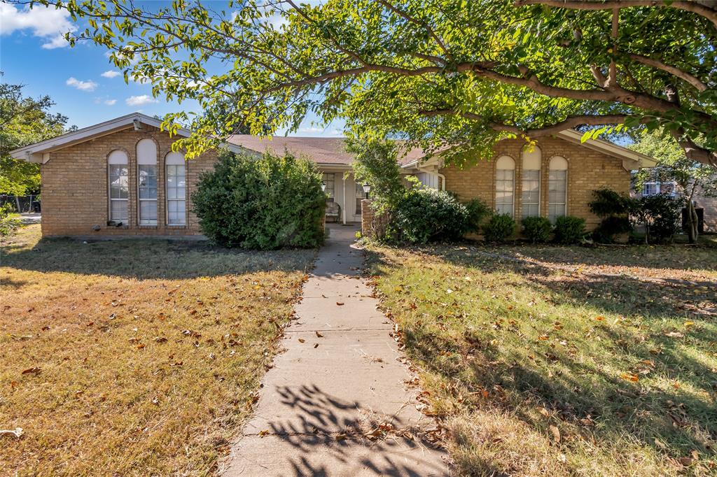 805 Irwin Drive, Unit B Hurst, TX 76053 - Photo 2 of 26 a front view of a house with a yard and garage