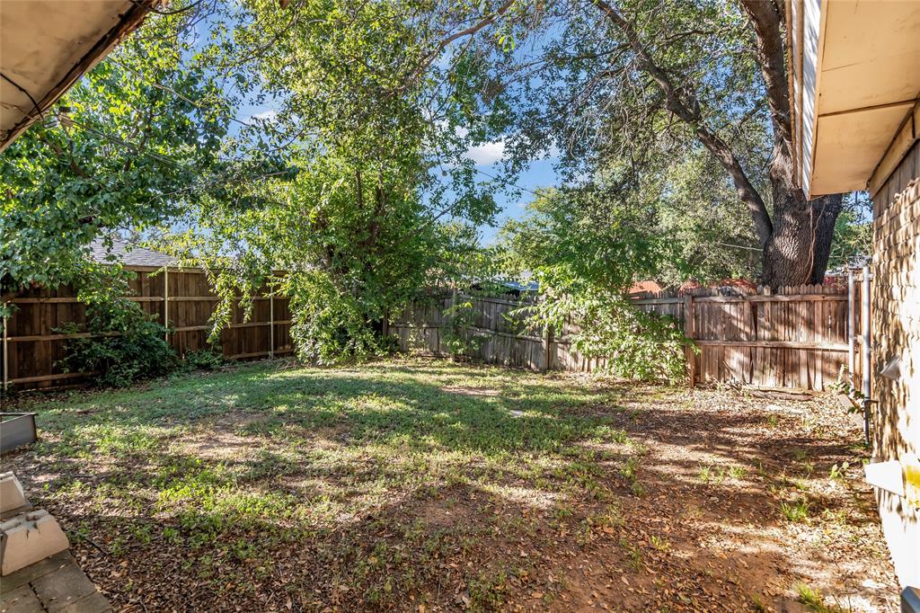 805 Irwin Drive, Unit B Hurst, TX 76053 - Photo 22 of 26 a view of a yard with plants and large trees