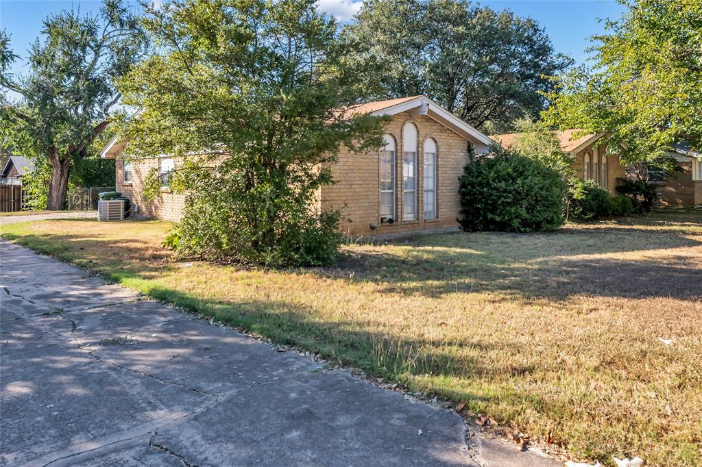 805 Irwin Drive, Unit B Hurst, TX 76053 - Photo 3 of 26 a view of a house with a yard and large trees