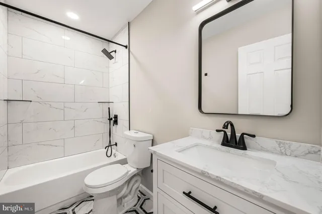 a bathroom with a sink toilet a mirror and shower