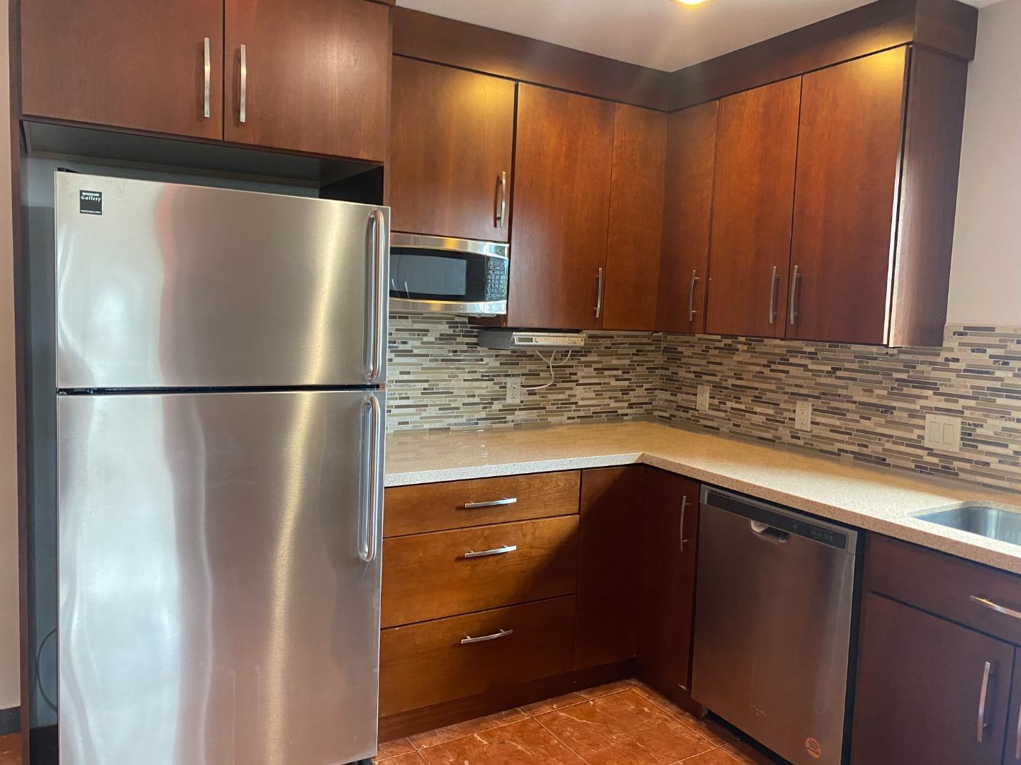 2625 Sequoia Way Belmont, CA 94002 - Photo 2 of 18 a kitchen with metallic refrigerator freezer and a dishwasher