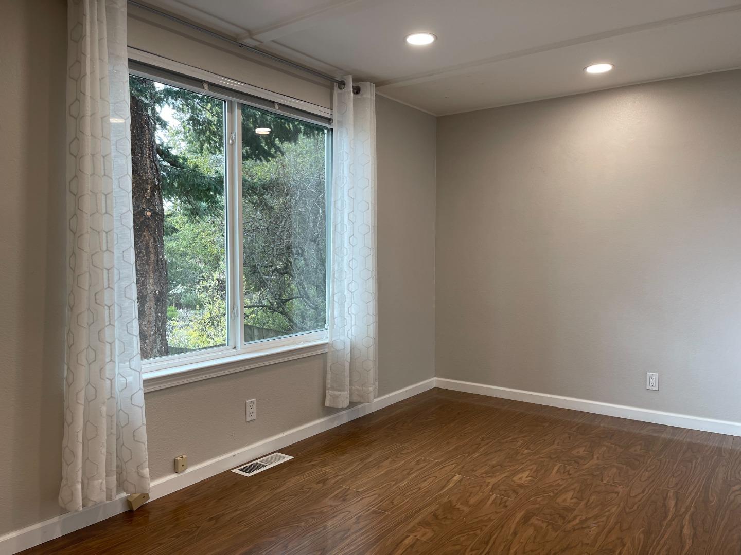 2625 Sequoia Way Belmont, CA 94002 - Photo 7 of 18 an empty room with wooden floor and windows