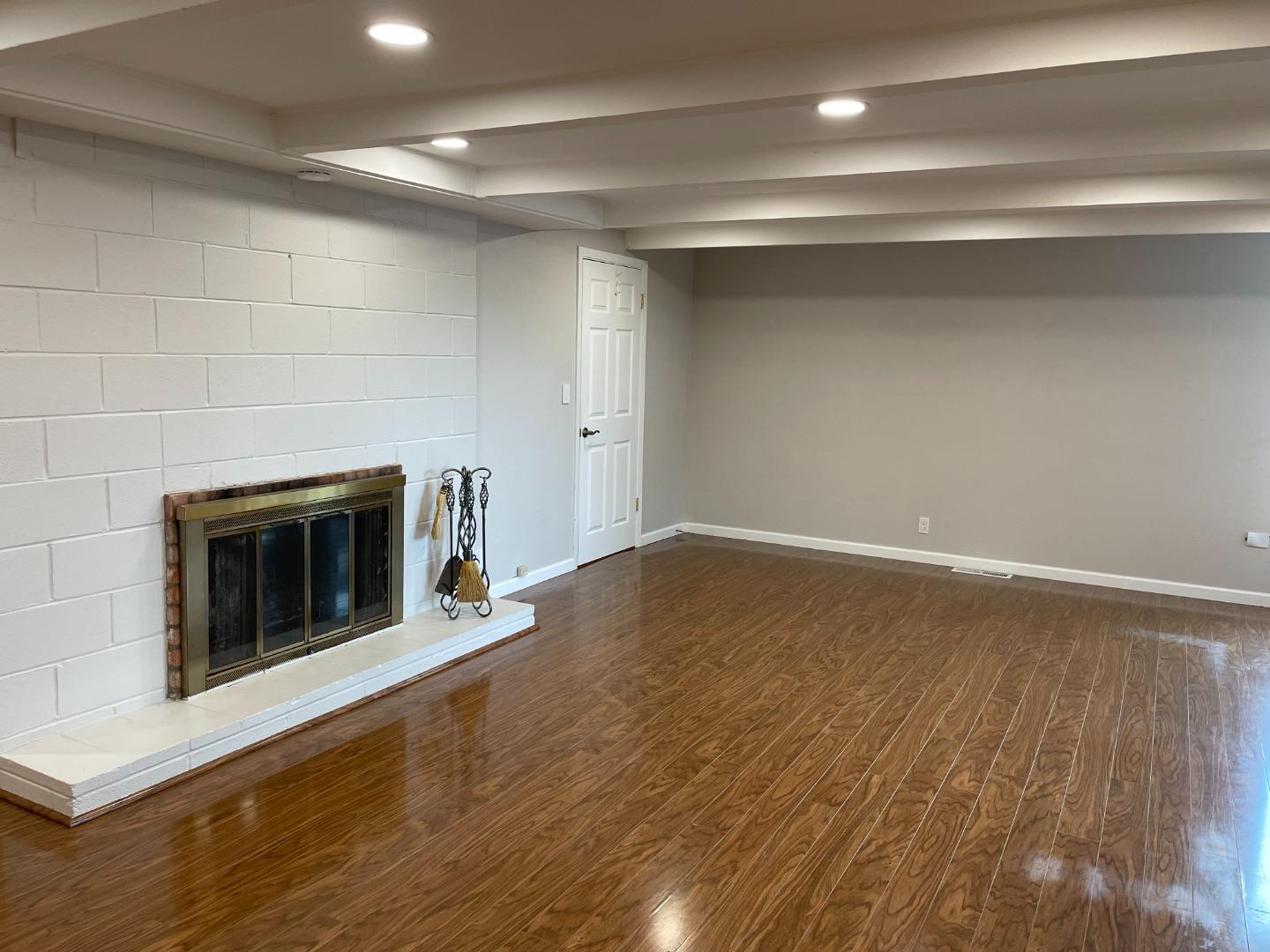 2625 Sequoia Way Belmont, CA 94002 - Photo 10 of 18 a hallway with wooden floor a fireplace and a window