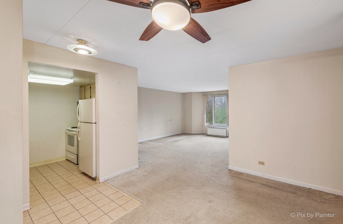 1 Renaissance Place, Unit 211 Palatine, IL 60067 - Photo 5 of 17 wooden floor in an empty room with a chandelier fan