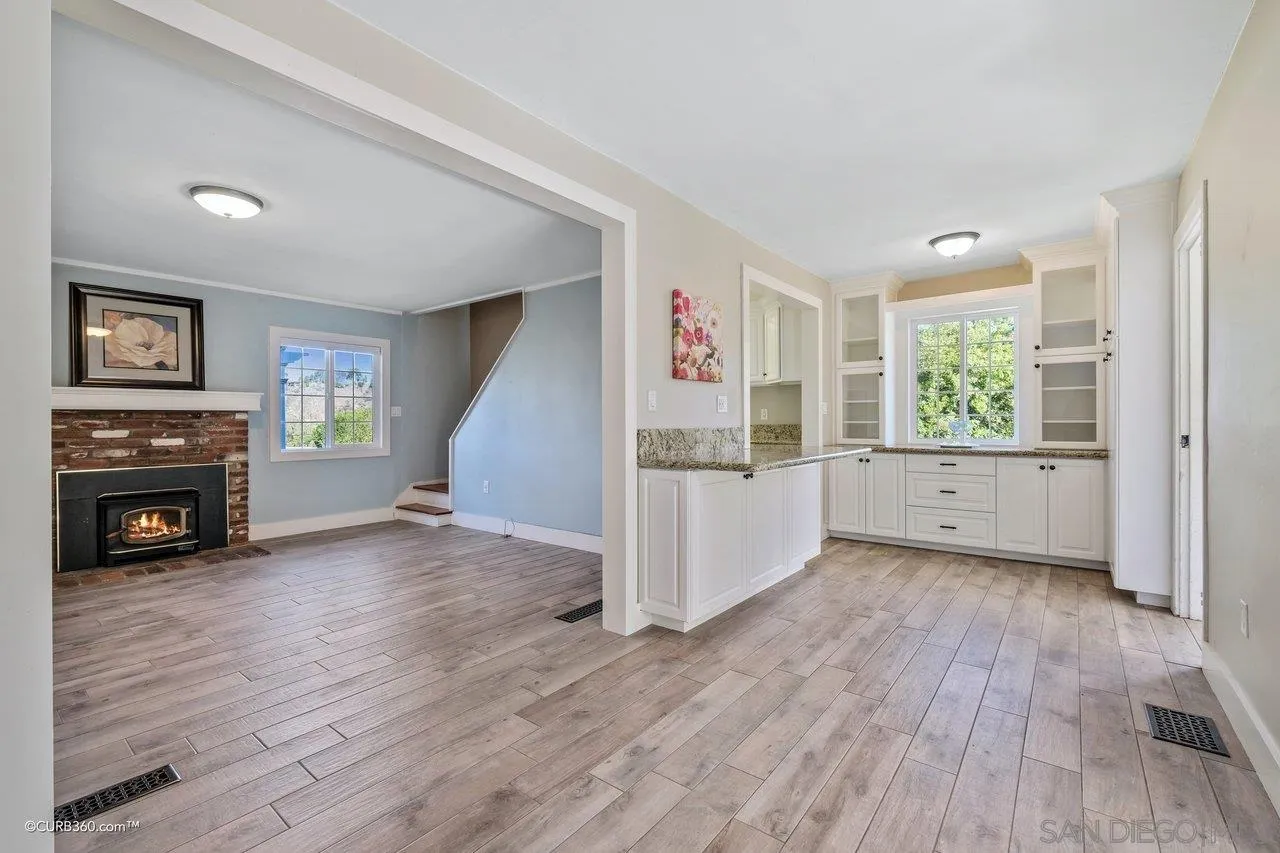 1544 Grove Road El Cajon, CA 92020 - Photo 21 of 42 a view of a livingroom with furniture a fireplace and wooden floor