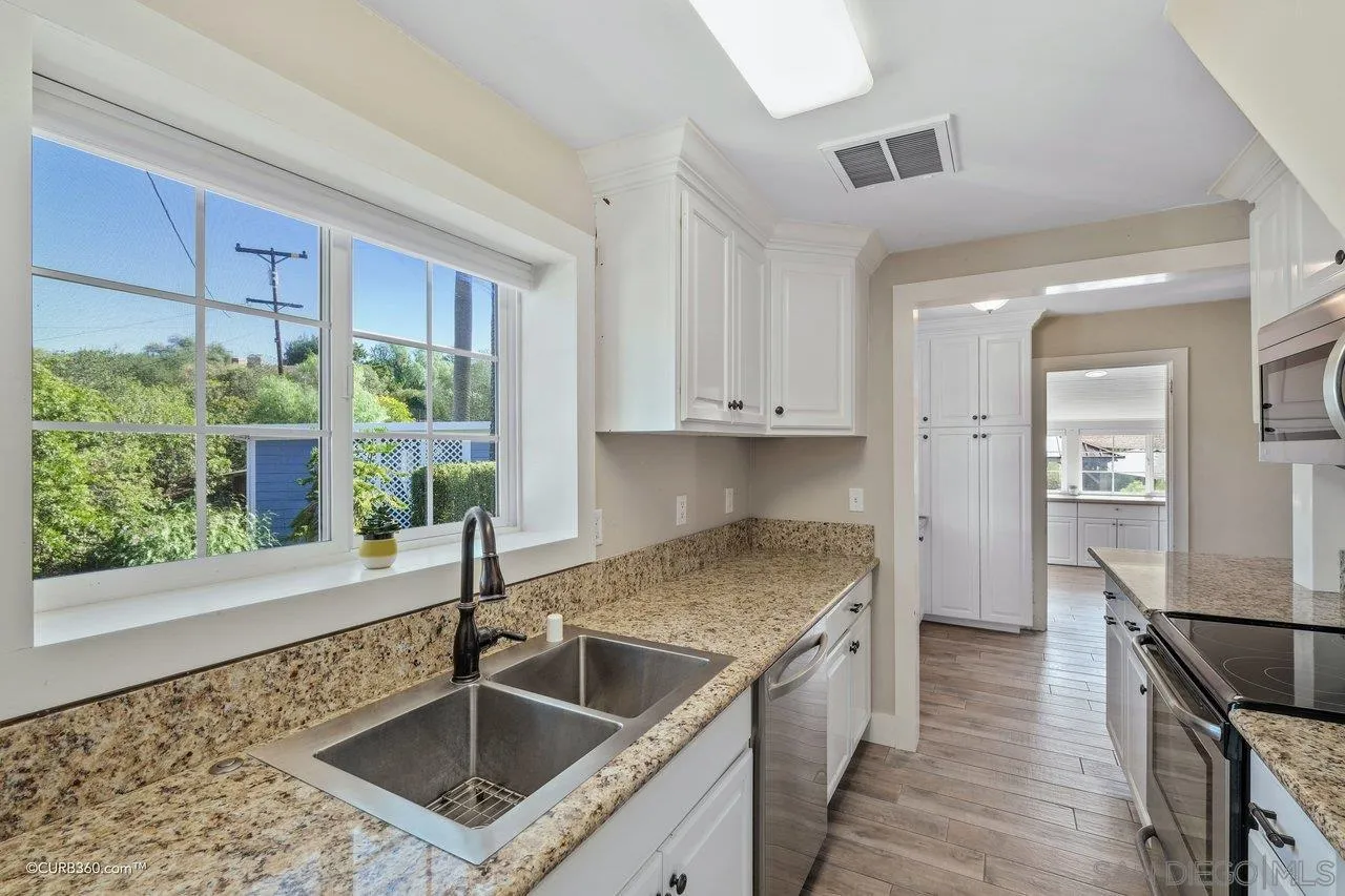 1544 Grove Road El Cajon, CA 92020 - Photo 22 of 42 a kitchen with a stove a sink and a refrigerator