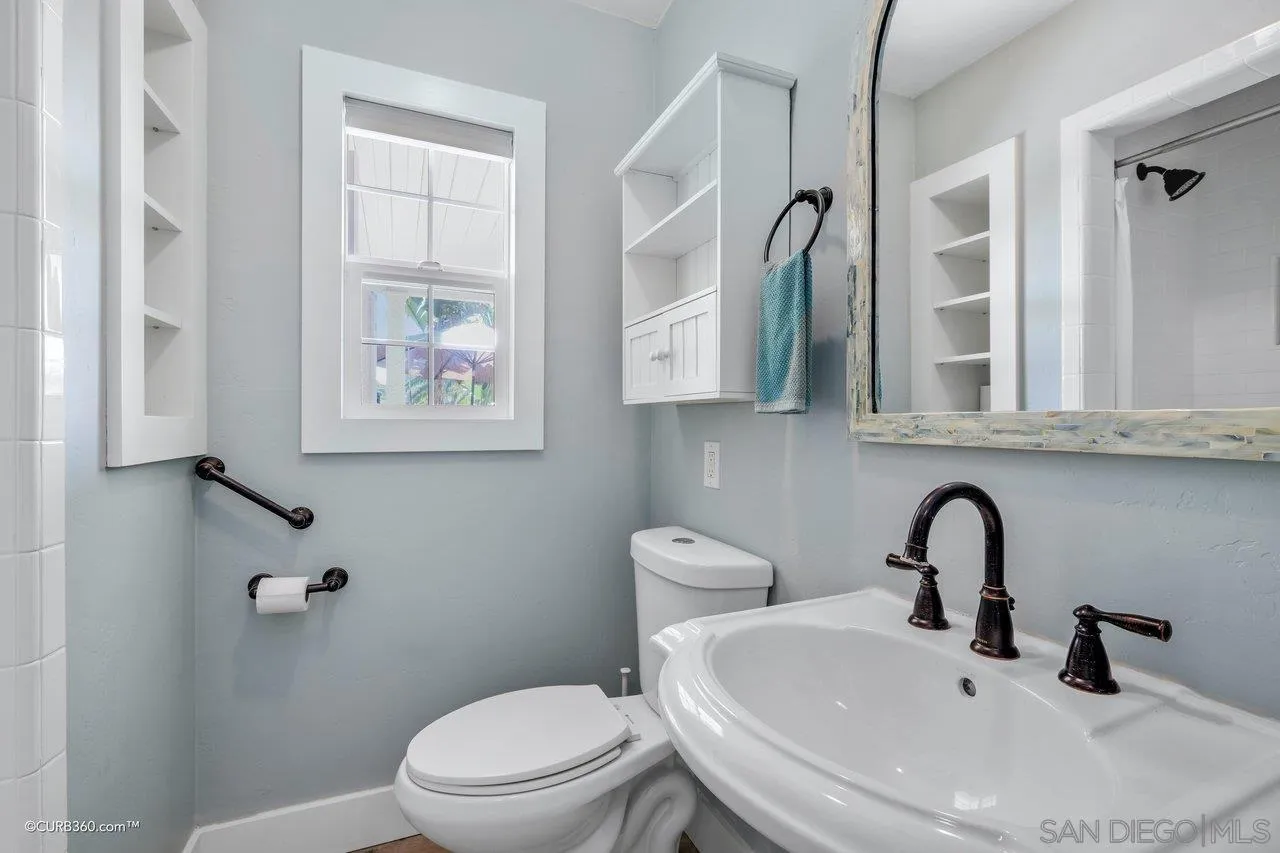 1544 Grove Road El Cajon, CA 92020 - Photo 25 of 42 a bathroom with a toilet sink and mirror