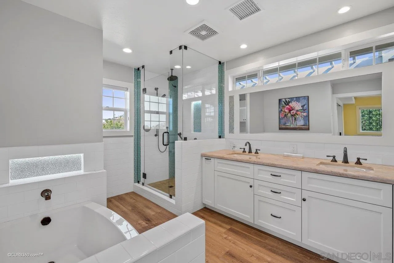 1544 Grove Road El Cajon, CA 92020 - Photo 29 of 42 a spacious bathroom with a double vanity sink large mirror and a bathtub