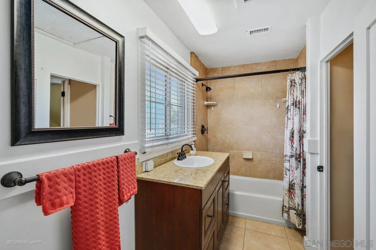 1544 Grove Road El Cajon, CA 92020 - Photo 31 of 42 a bathroom with a bathtub and a mirror