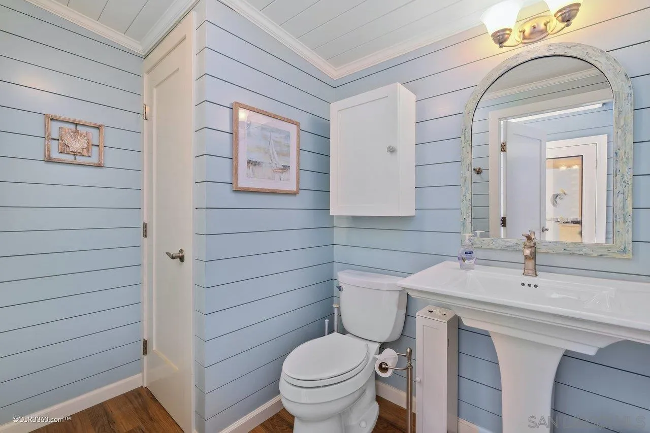 1544 Grove Road El Cajon, CA 92020 - Photo 36 of 42 a bathroom with a toilet a sink and mirror