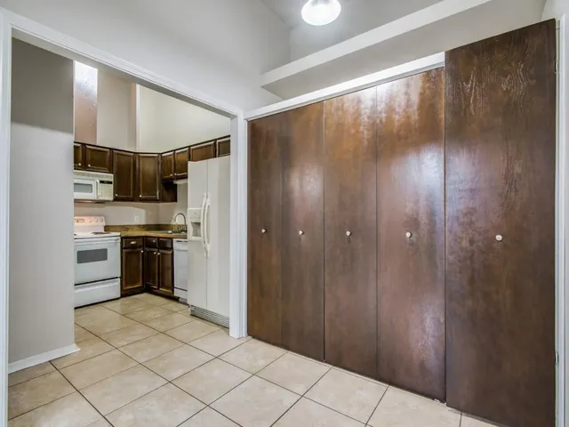 a kitchen with stainless steel appliances a refrigerator and a stove top oven