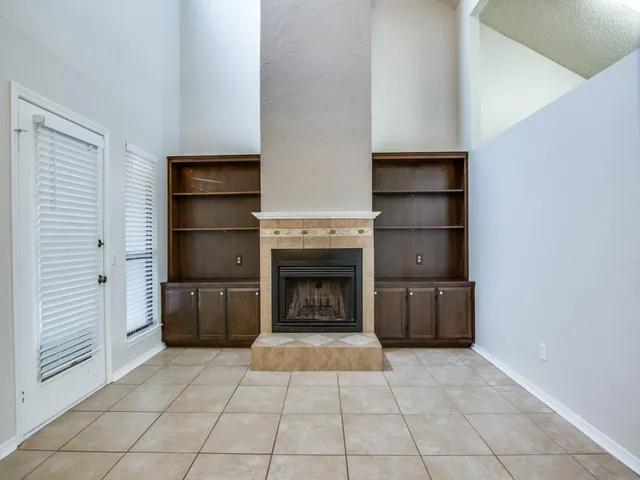a view of an empty room and fire place