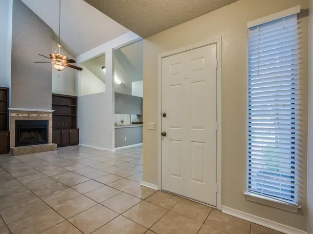 a view of a hallway with a fireplace and a window