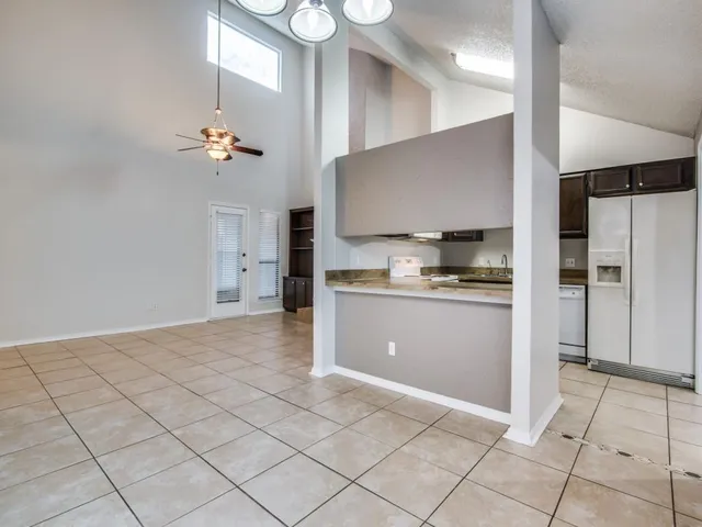 a large kitchen with stainless steel appliances a refrigerator and a stove top oven